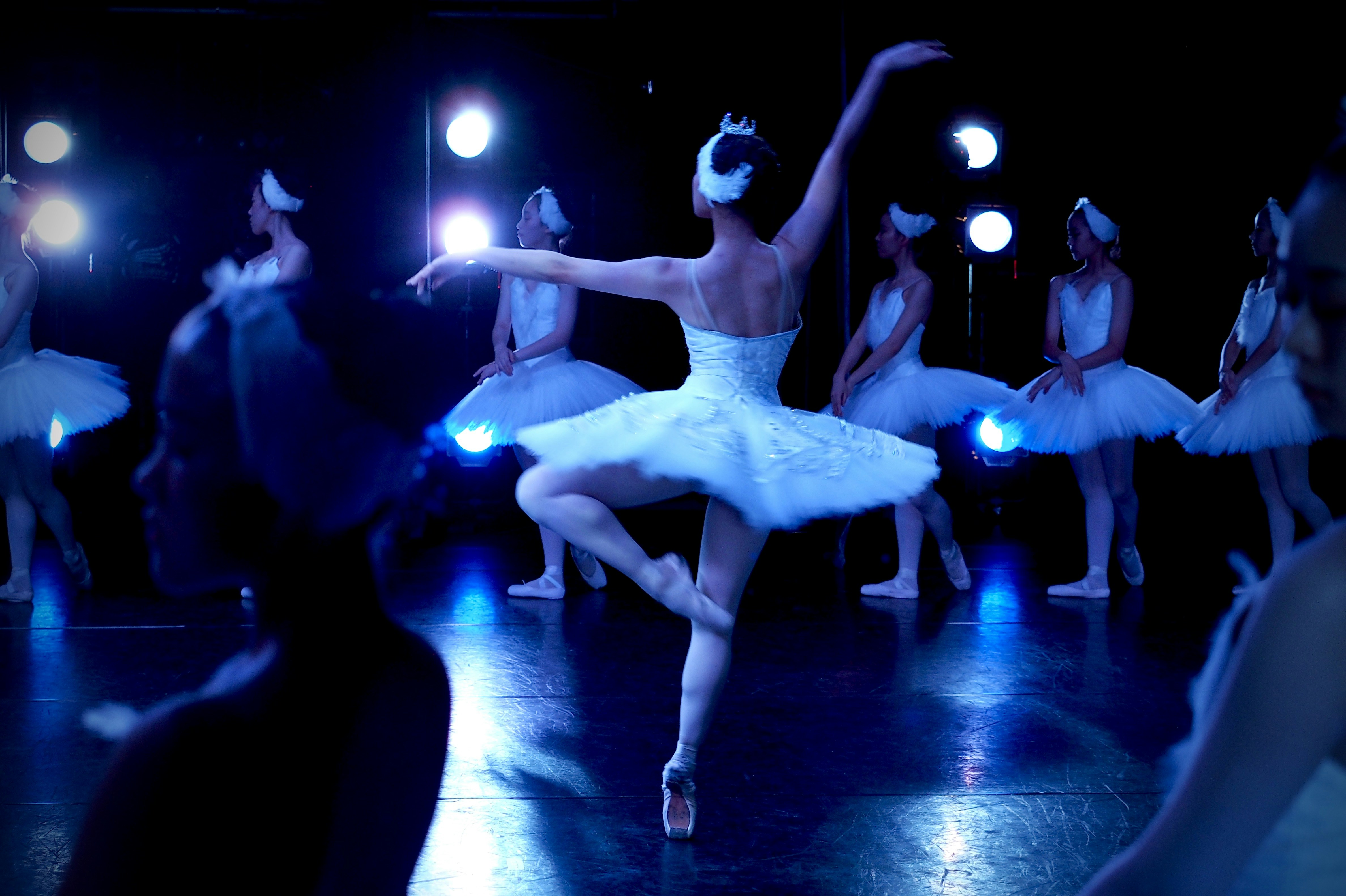 woman in white dress dancing on stage
