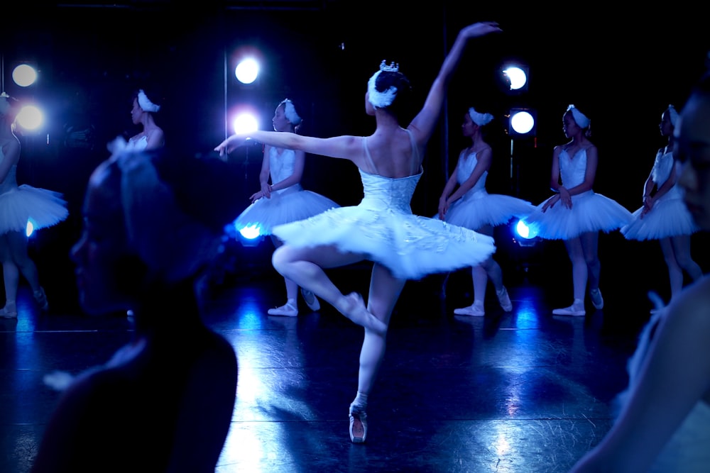 woman in white dress dancing on stage