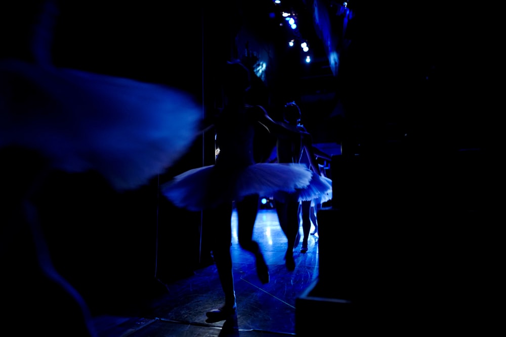 man in white dress shirt standing on stage