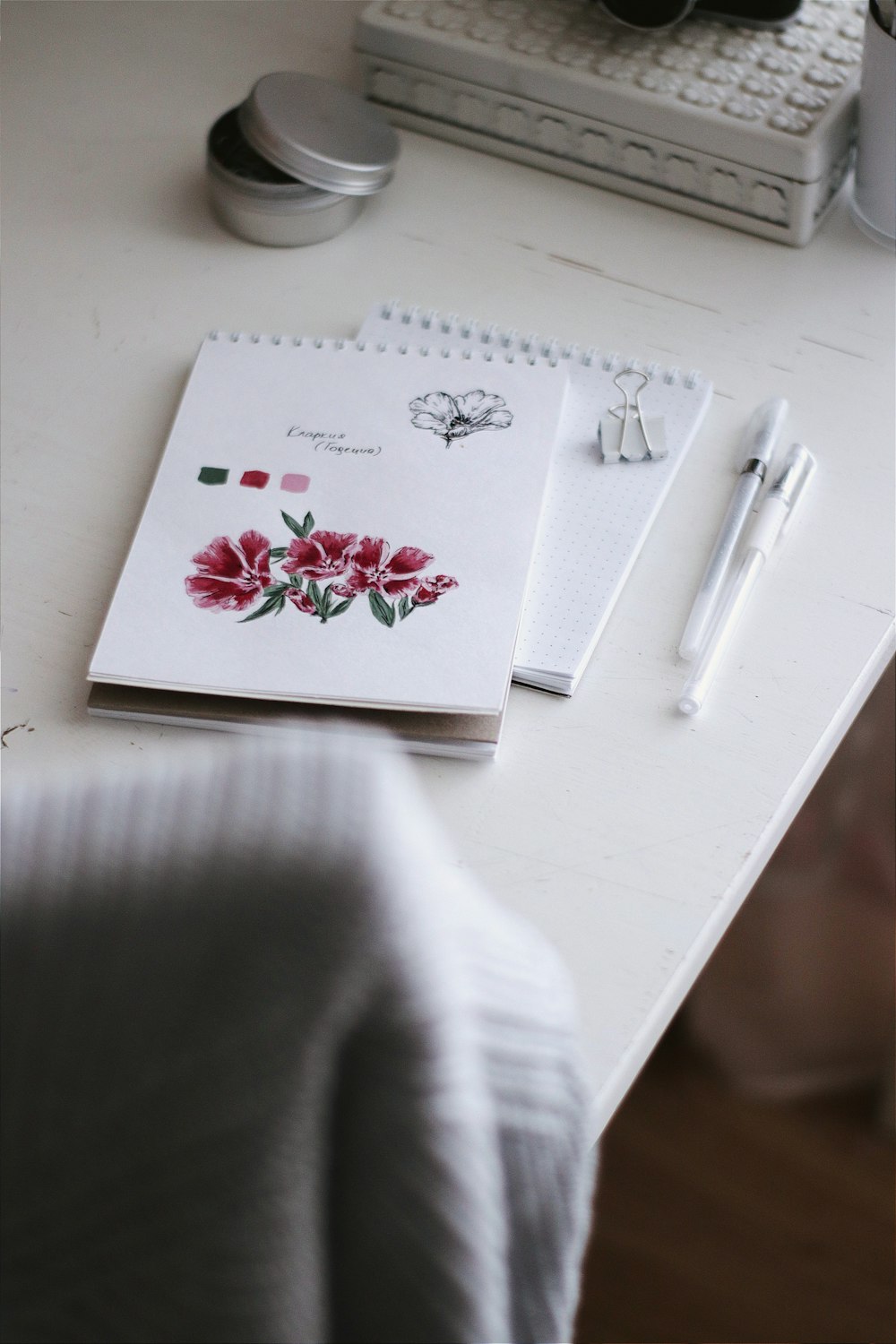 white red and green floral card on white table