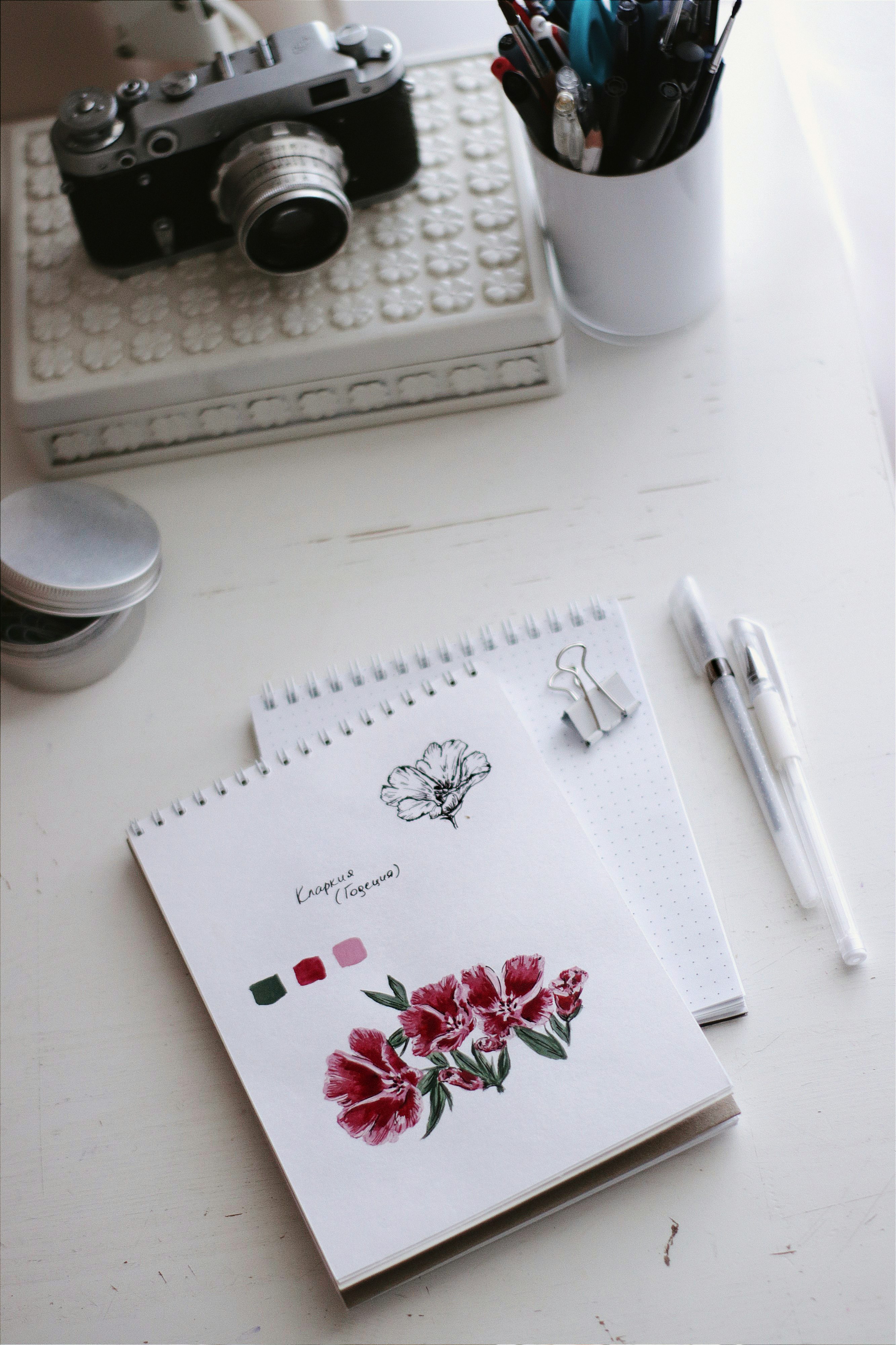 white printer paper with red rose on white table