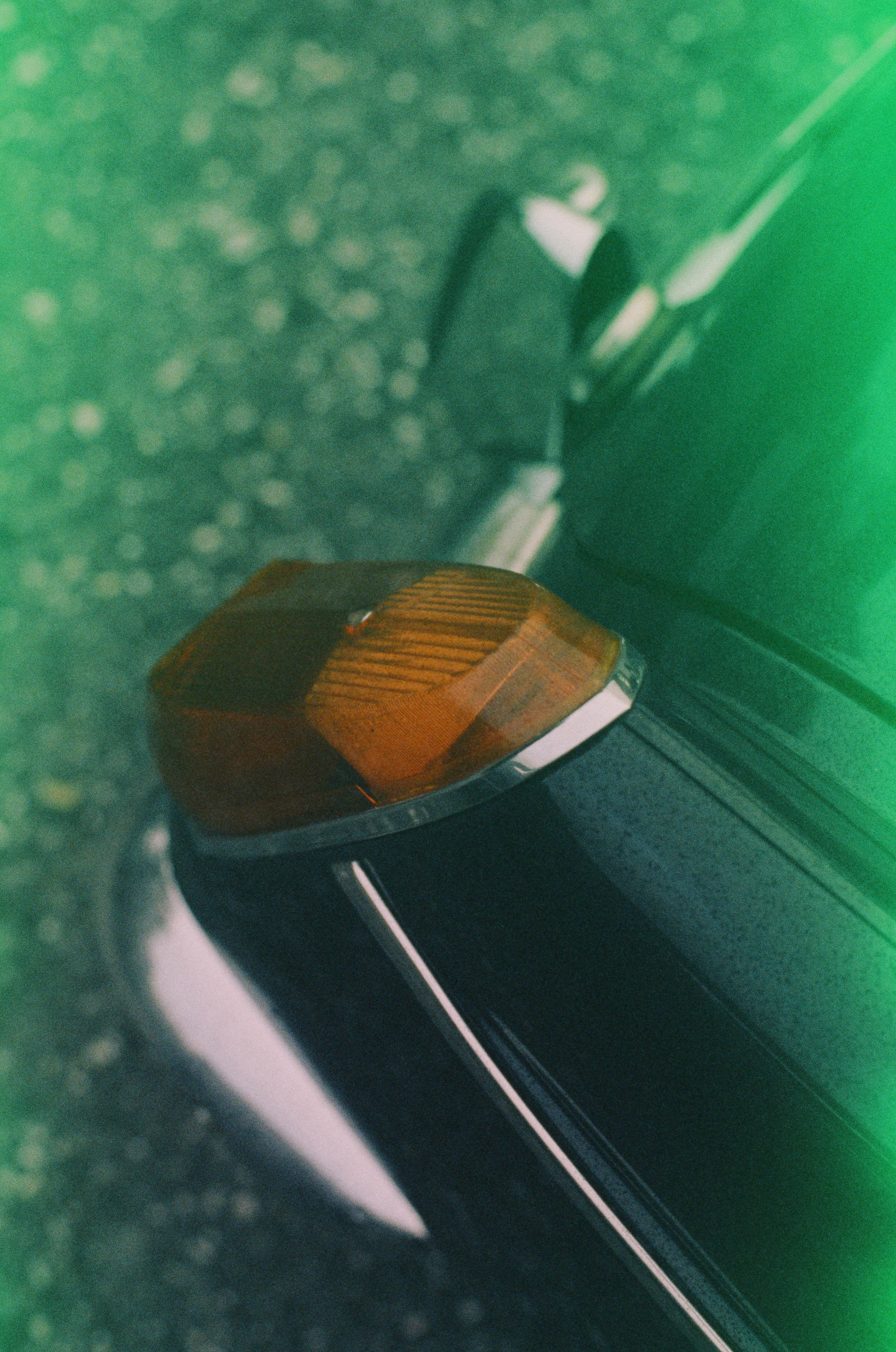 Vintage classic british oldtimer – MG chrome rear lights. Incorrect exposure due to the expired date and probably incorrect storage. Made with Leica R7 (1994) and Summilux-R 1.4 50mm (1983). Hi-Res analog scan by: www.totallyinfocus.com – Fujichrome Provia 400 (expired 2004)