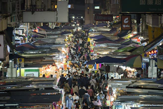 A candid street photo capturing lively market scenes with colorful stalls.
