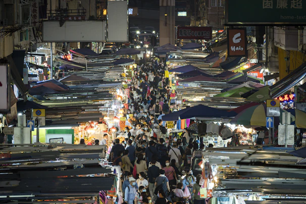 A candid street photo capturing lively market scenes with colorful stalls.