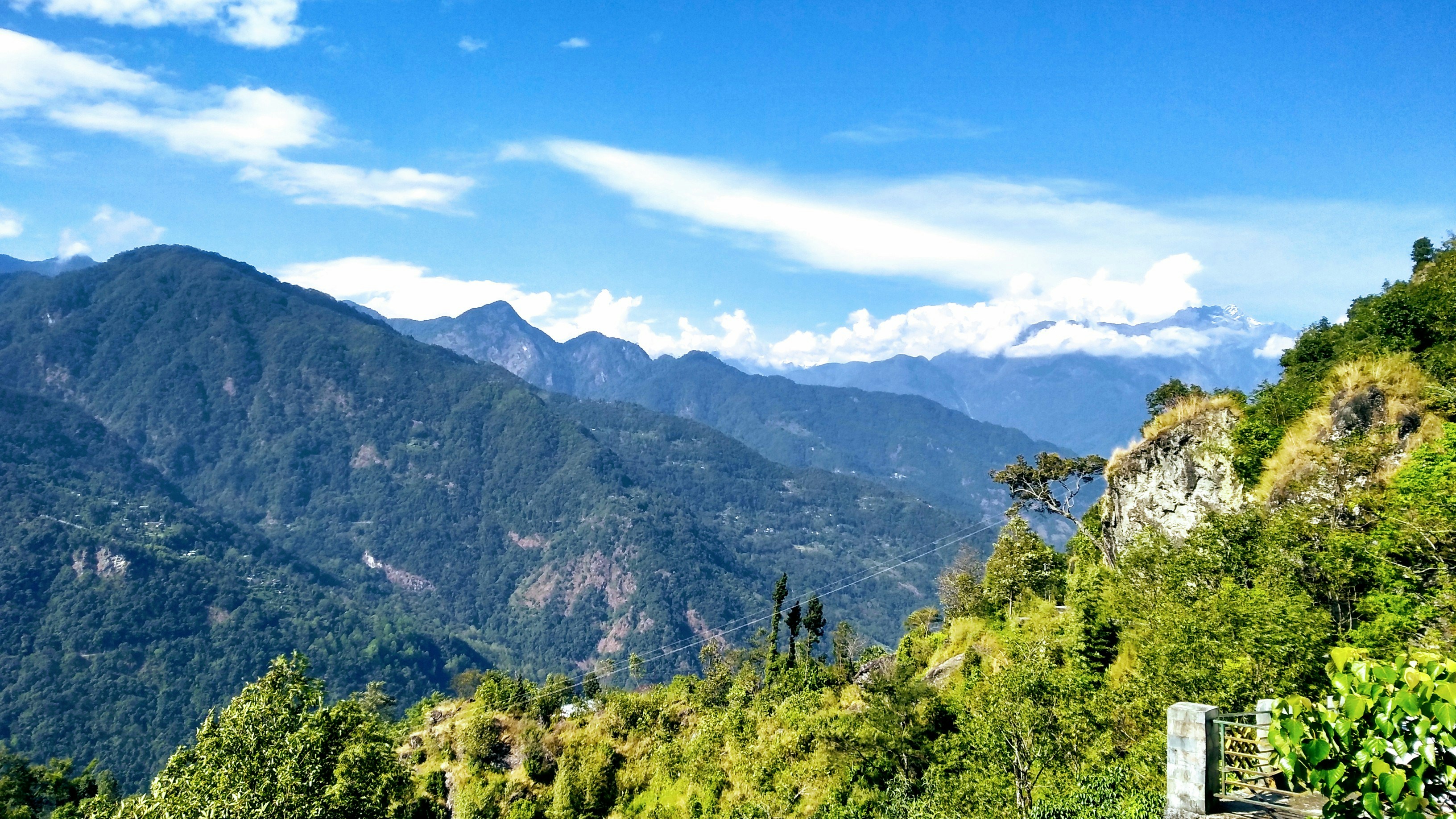 A panoramic view of a Colombian national park with mountains and rivers under a clear sky