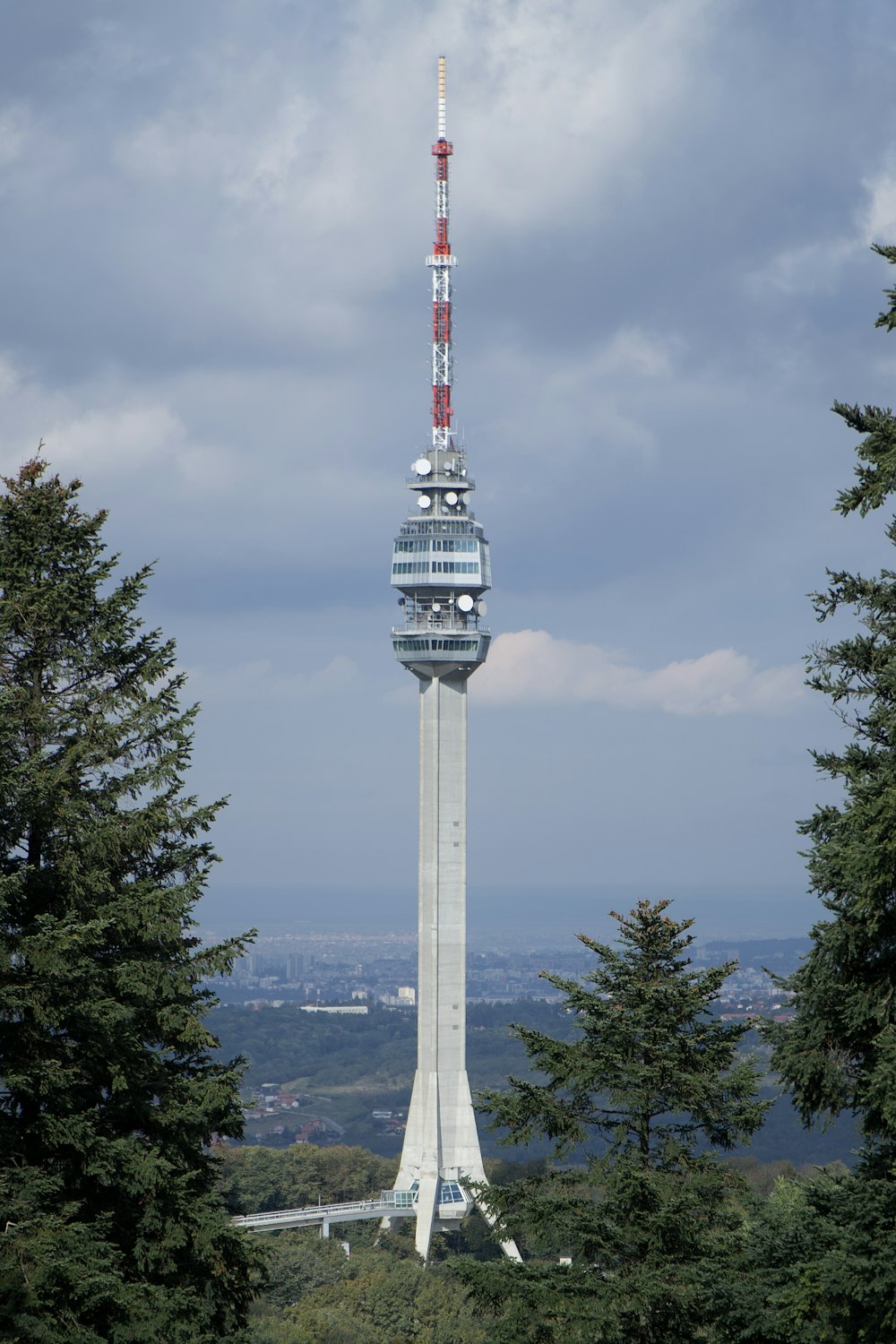 white and red tower under cloudy sky during daytime