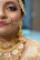 Close-up of a young Indian woman accessorizing with elegant jewelry.
