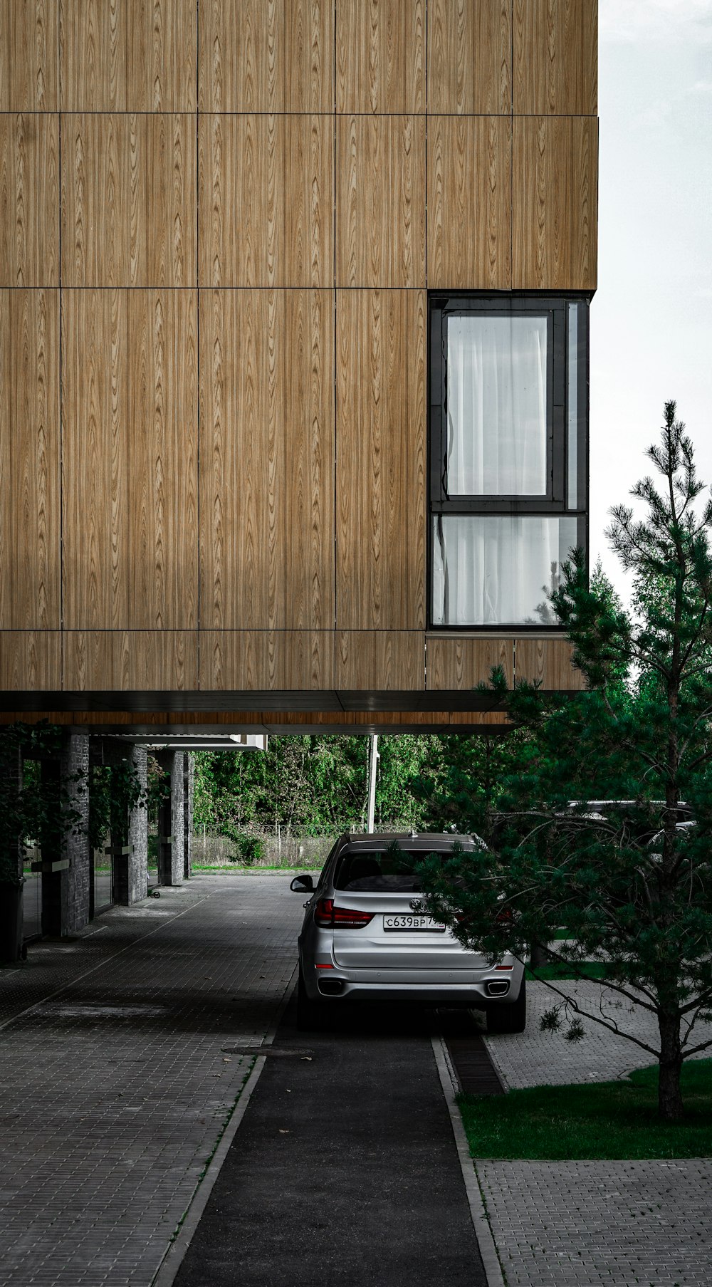 brown wooden house near green trees during daytime