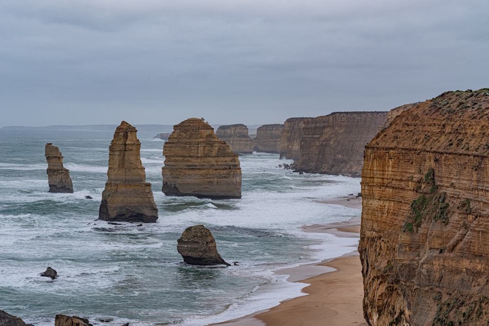 brown rock formation on sea shore during daytime