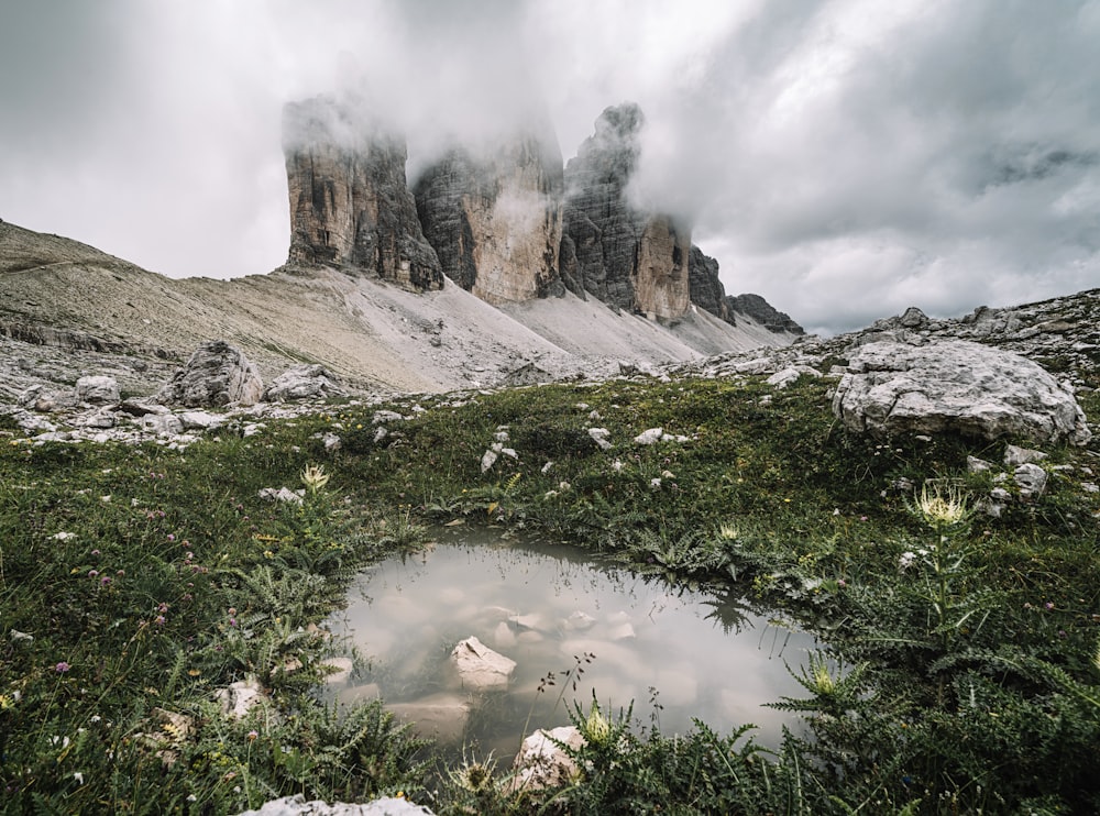 gray rocky mountain under white clouds during daytime