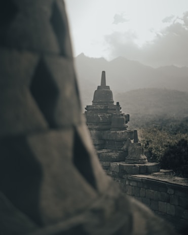 A scenic view of Borobudur Temple surrounded by lush greenery.