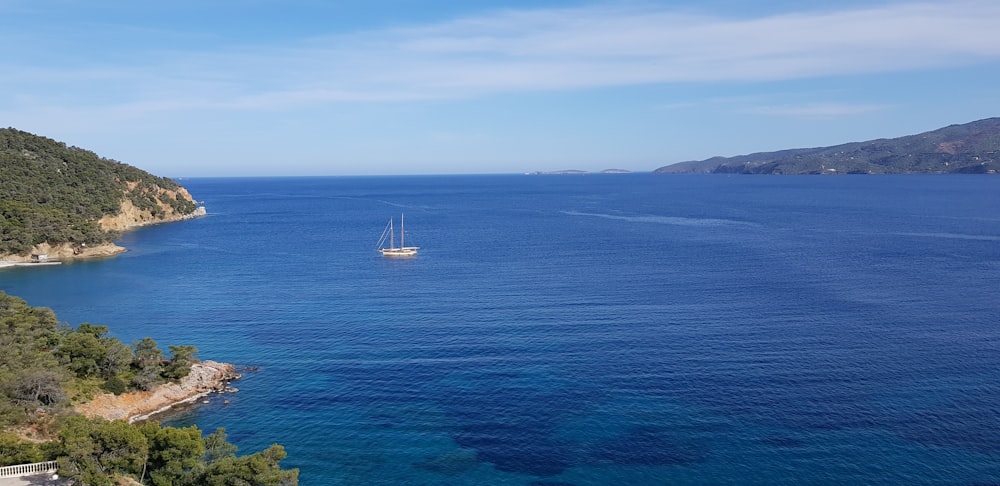 white boat on sea during daytime