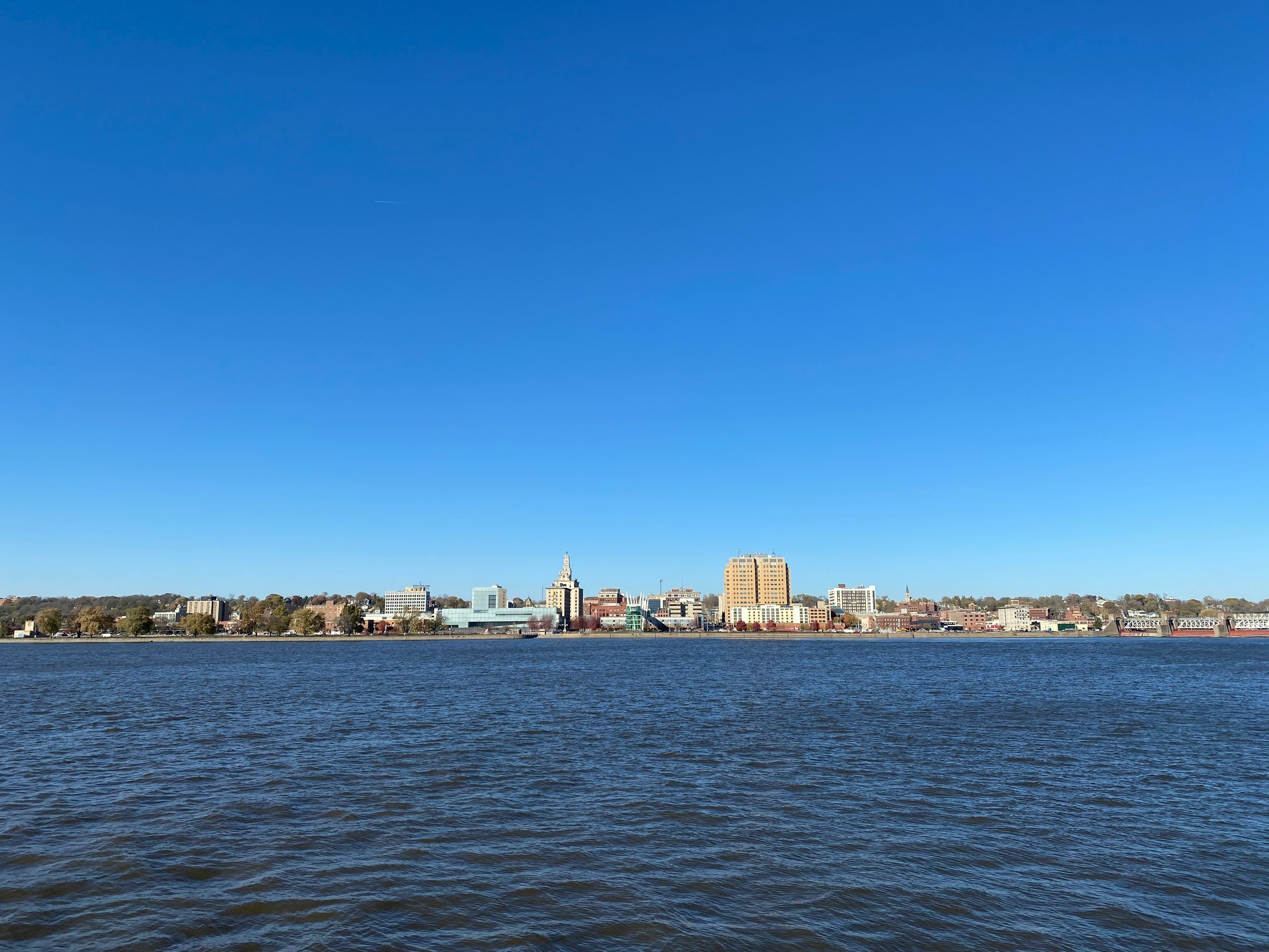 city skyline across body of water during daytime