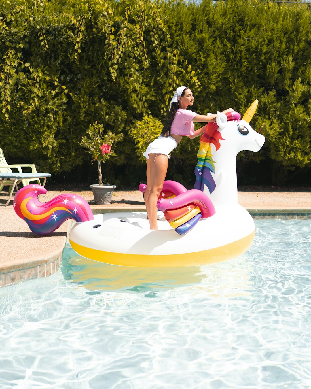 woman in white and pink bikini on white and yellow inflatable pool float during daytime