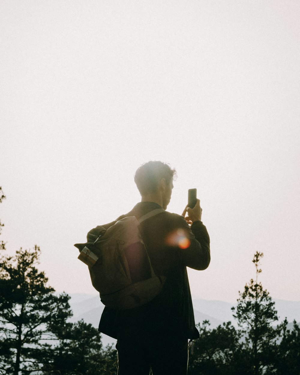 silhouette of man standing during daytime