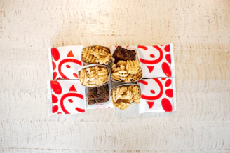 A colorful spread of fast food items including a burger, fries, and a milkshake on a wooden table.