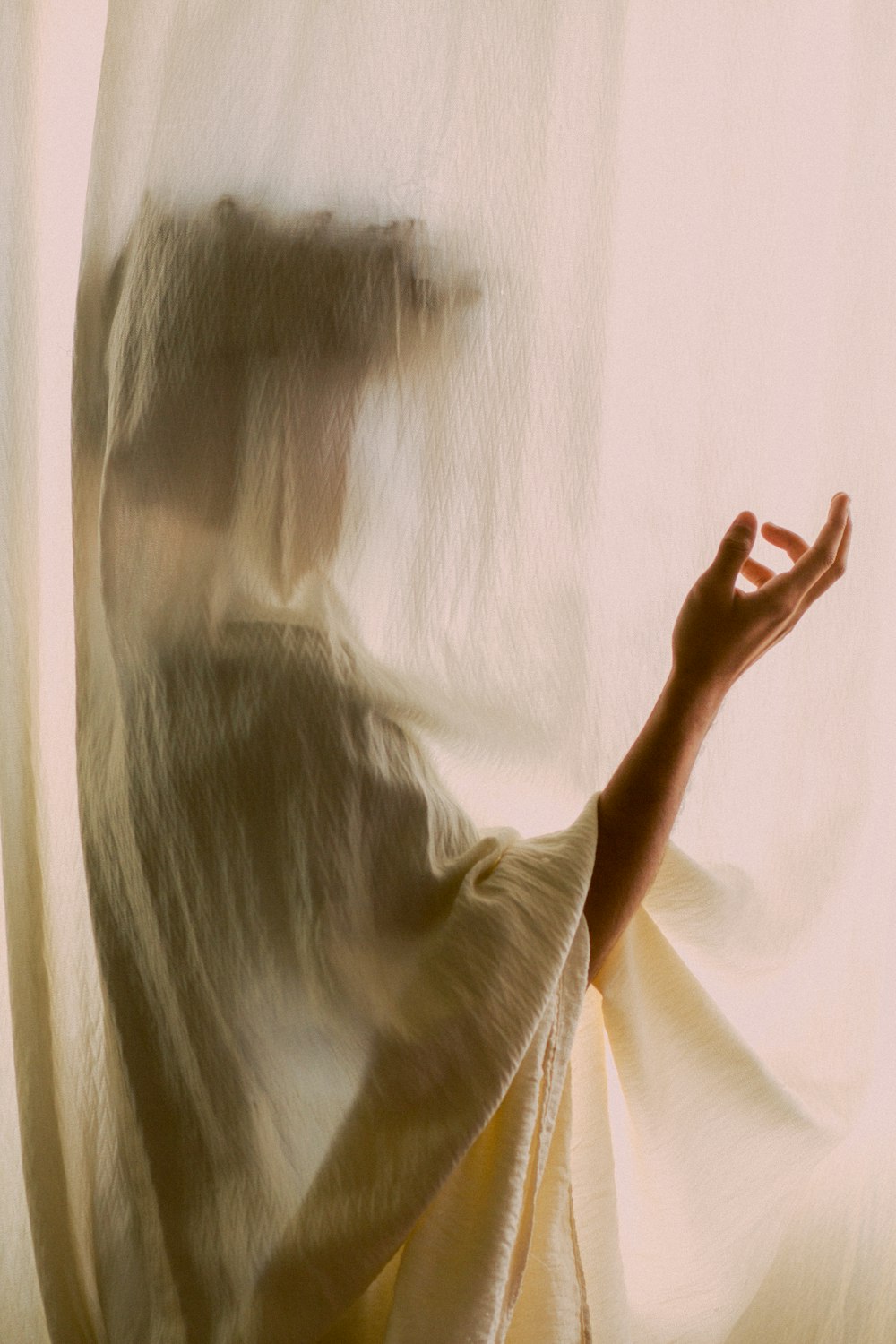 woman in white shirt covering her face