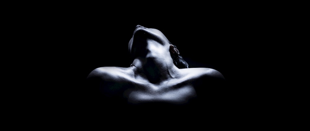 topless woman with black background