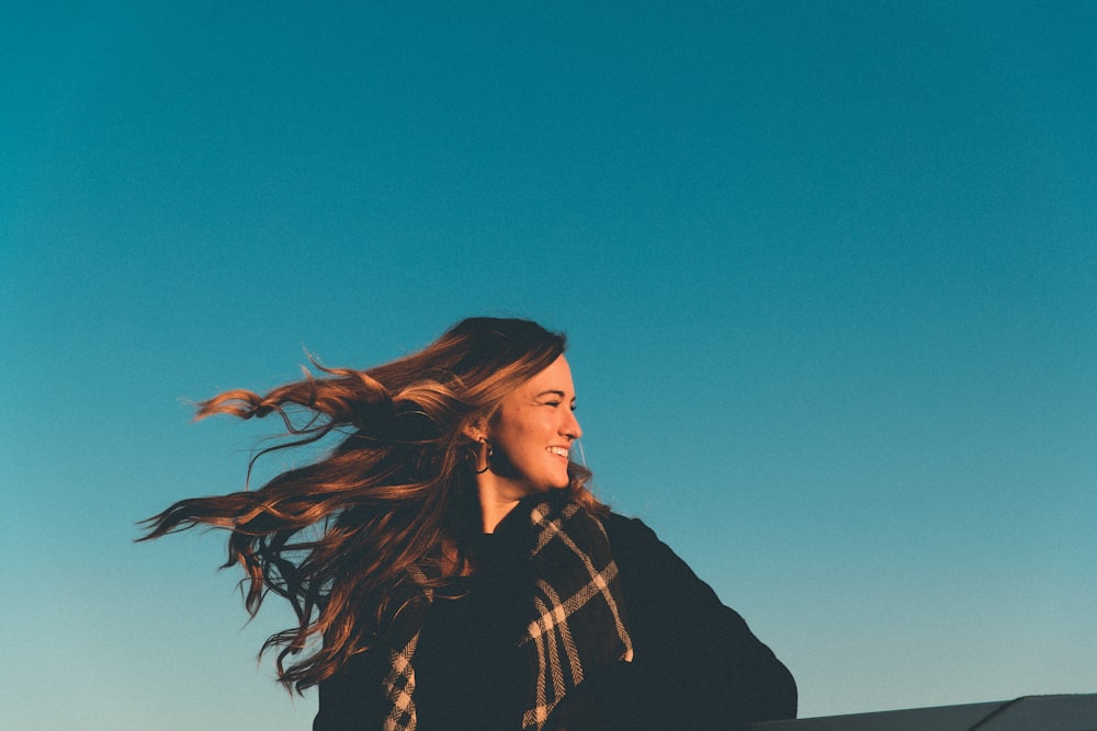 woman in black jacket standing under blue sky during daytime