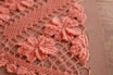 A vibrant crochet art piece showcasing lavender and gold colors.