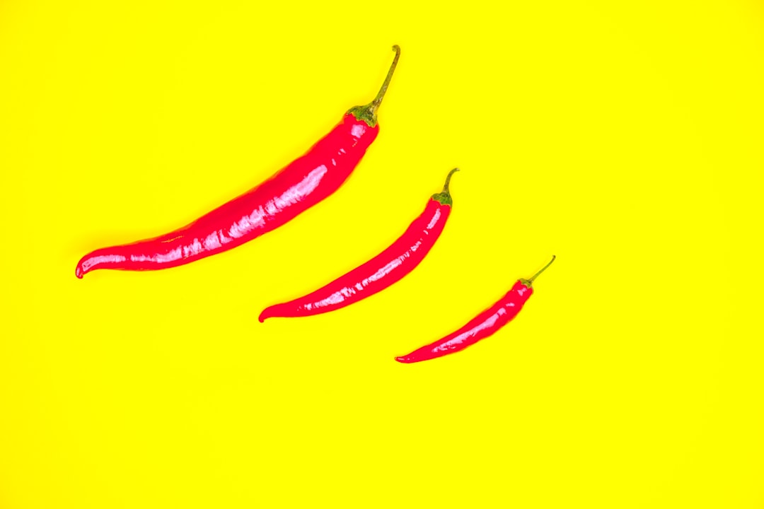 red chili on yellow surface