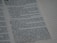 Text from a religious or spiritual book is visible on an open page. The words are printed in a formal font, and the page is filled with neatly organized columns of text. The focus is on a specific passage that appears to be discussing blessings and protection.