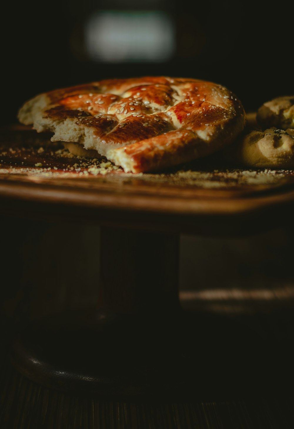 a pizza sitting on top of a wooden table