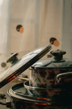A warm home kitchen setting showing a happy family cooking with Royal Prestige cookware.