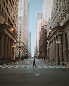 man in black jacket and black pants walking on sidewalk during daytime