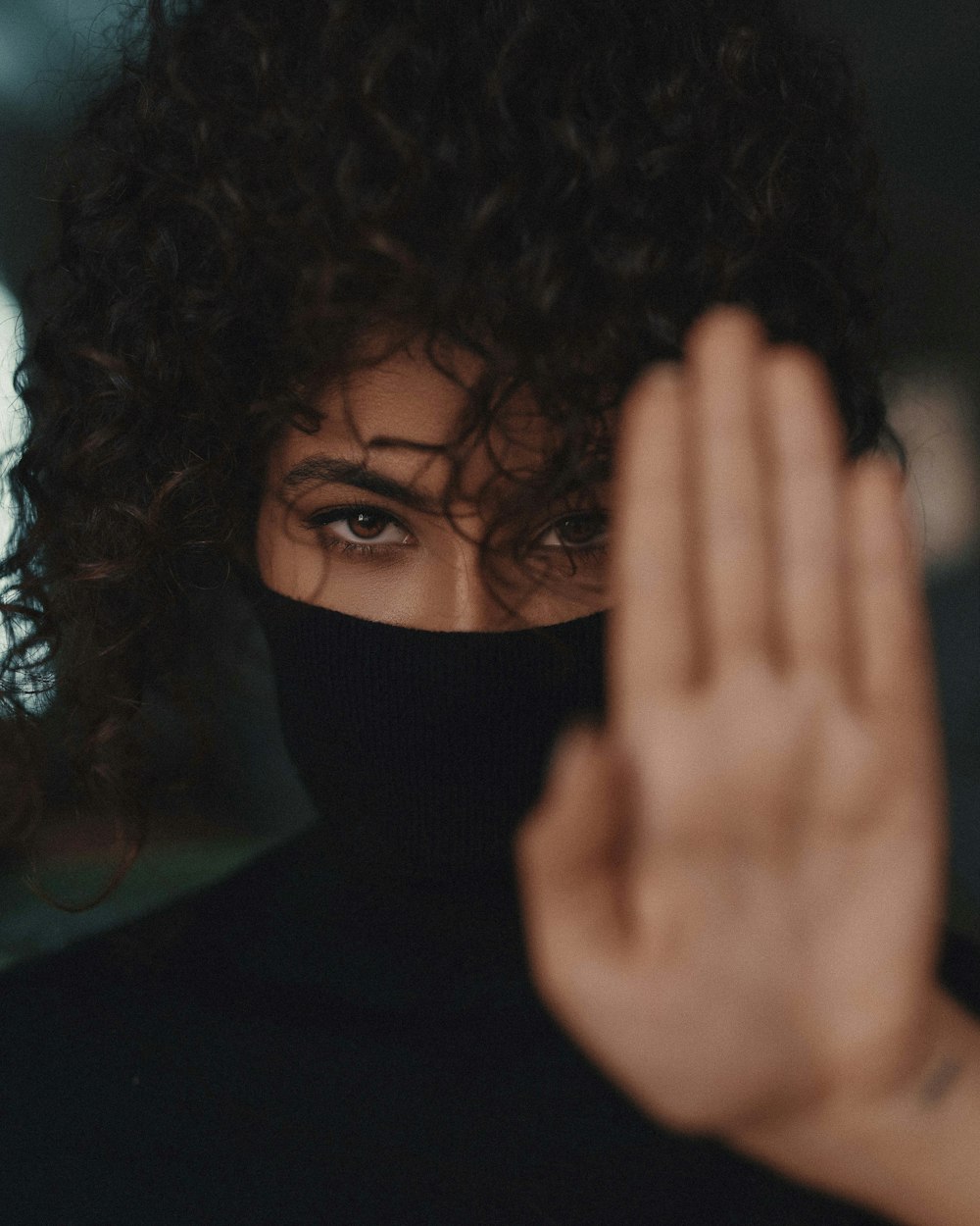 woman covering her face with her hair