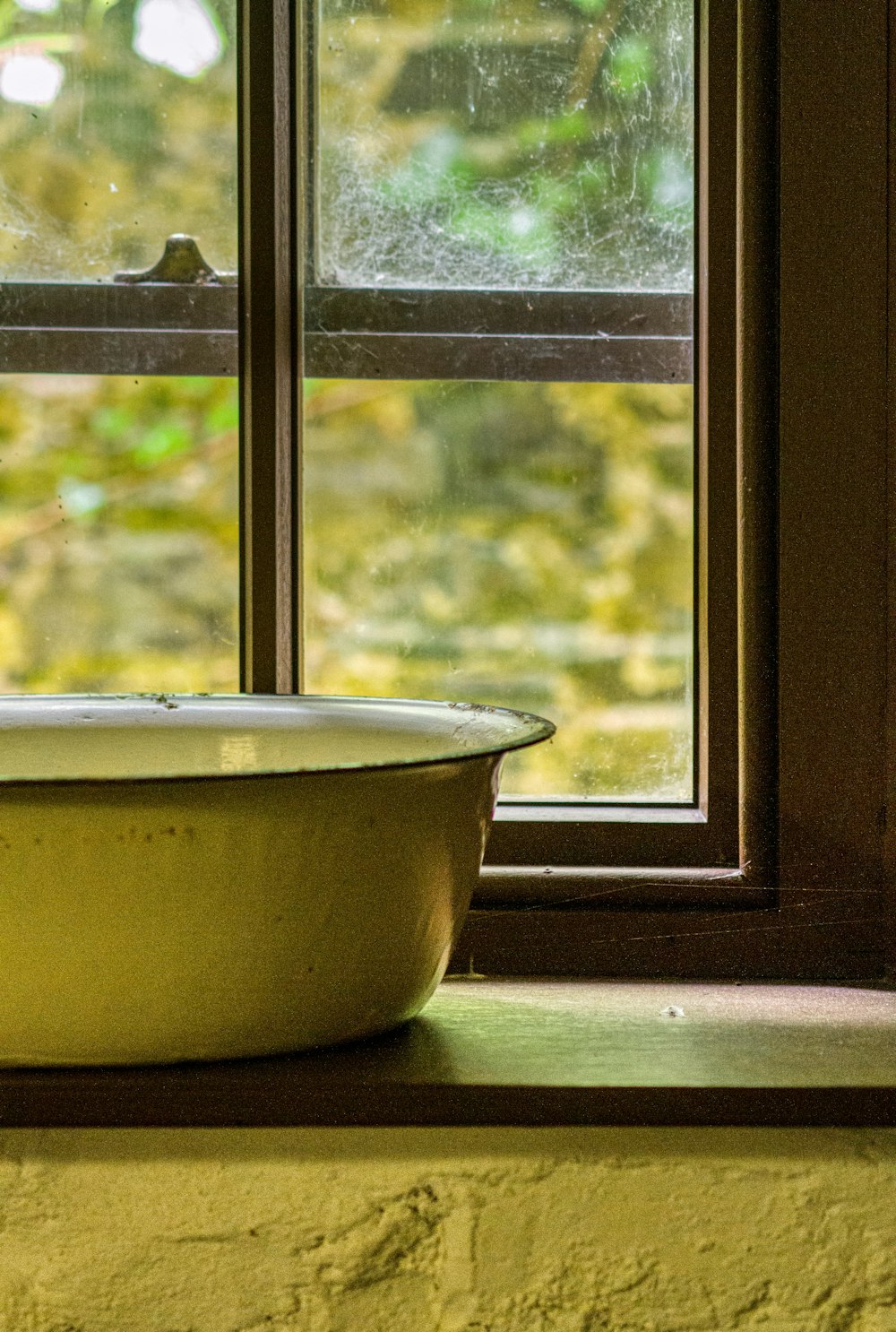 yellow ceramic bowl on window