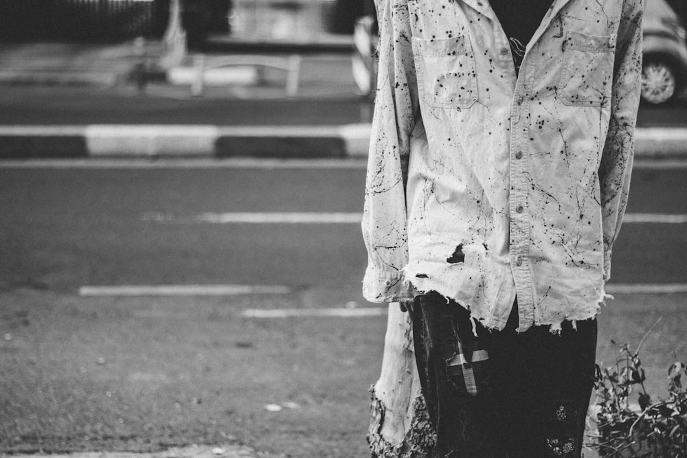 grayscale photo of woman in button up shirt and pants