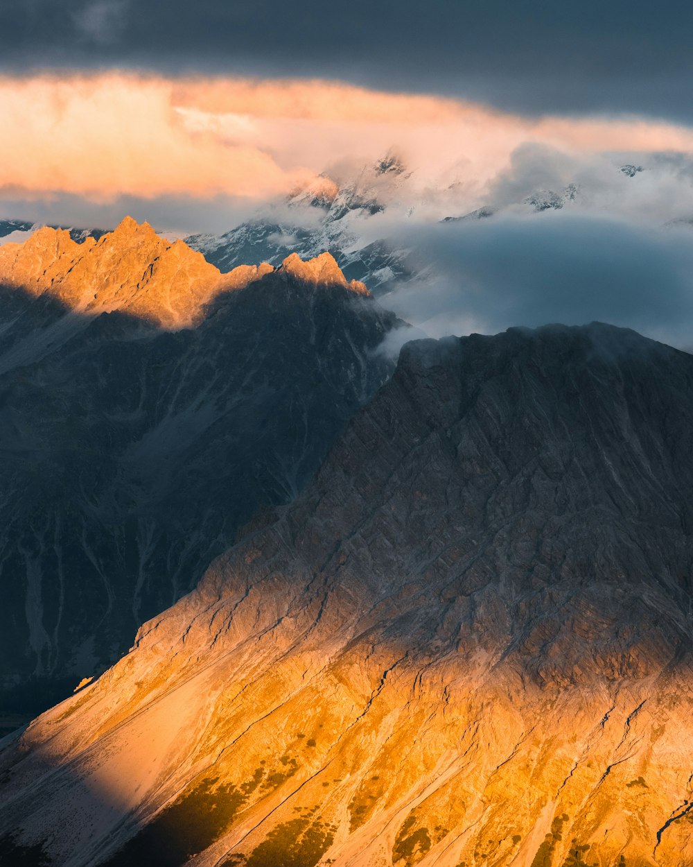 brown and gray mountains under white clouds during daytime