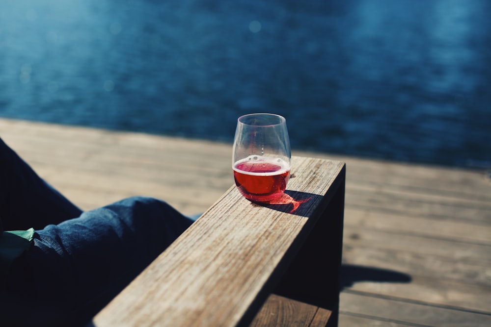 clear drinking glass on brown wooden table