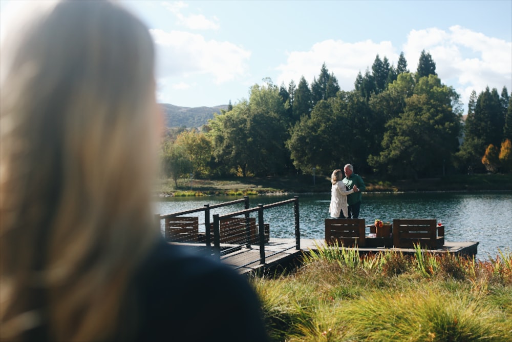 man and woman standing on dock during daytime