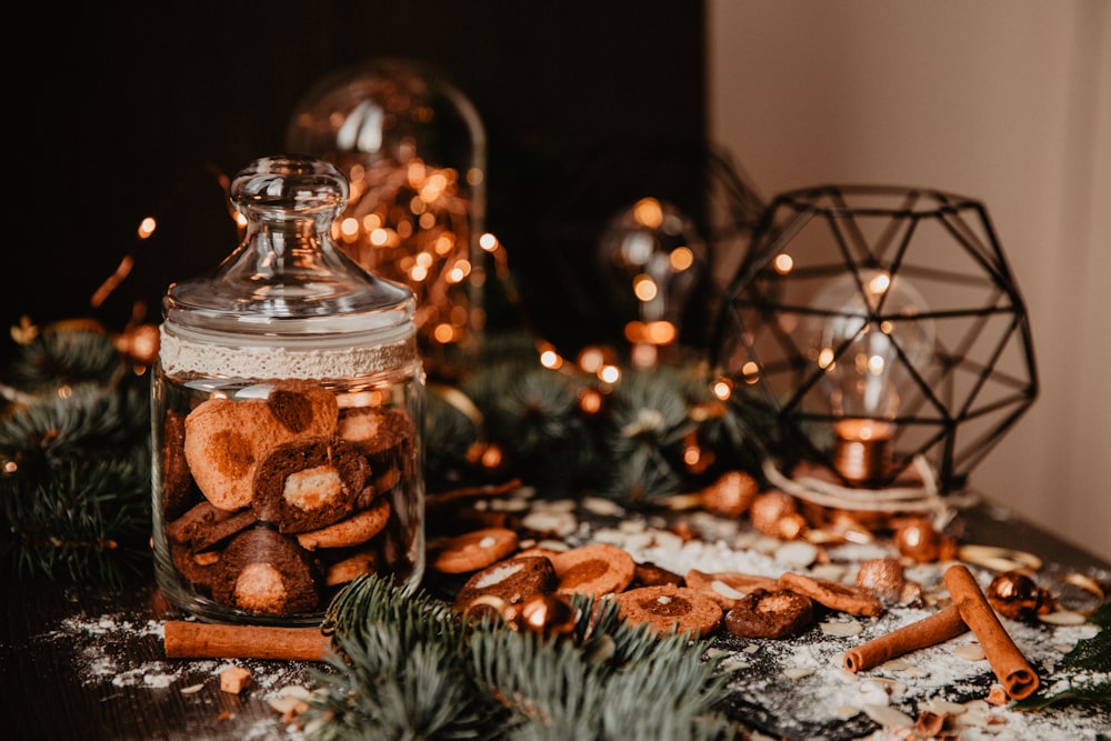 clear glass jar with brown and white stones on brown wooden table