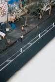 woman in white shirt walking on sidewalk during daytime