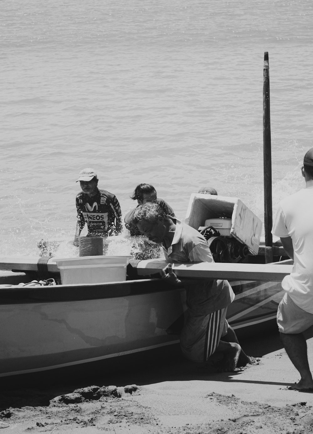 grayscale photo of man and woman riding boat