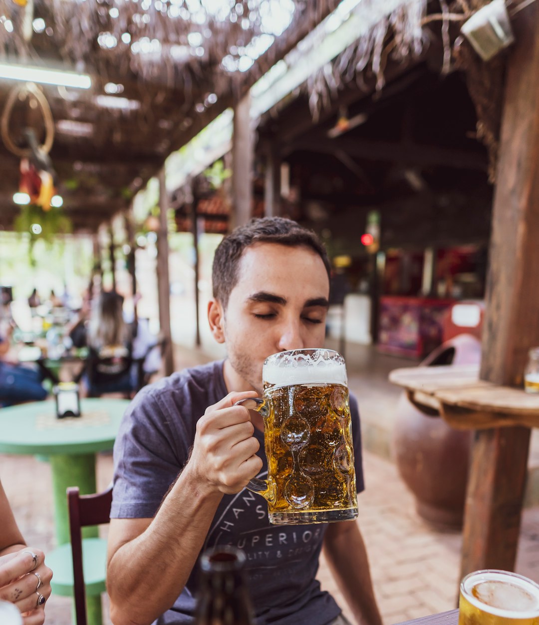  man in gray crew neck t shirt drinking beer cold tap