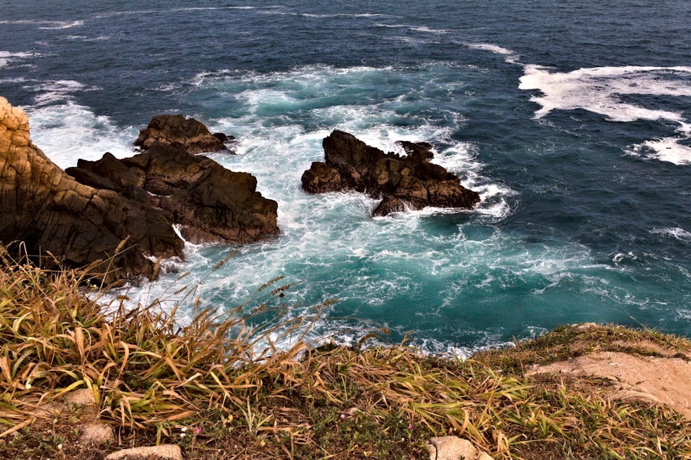 brown rock formation on sea during daytime