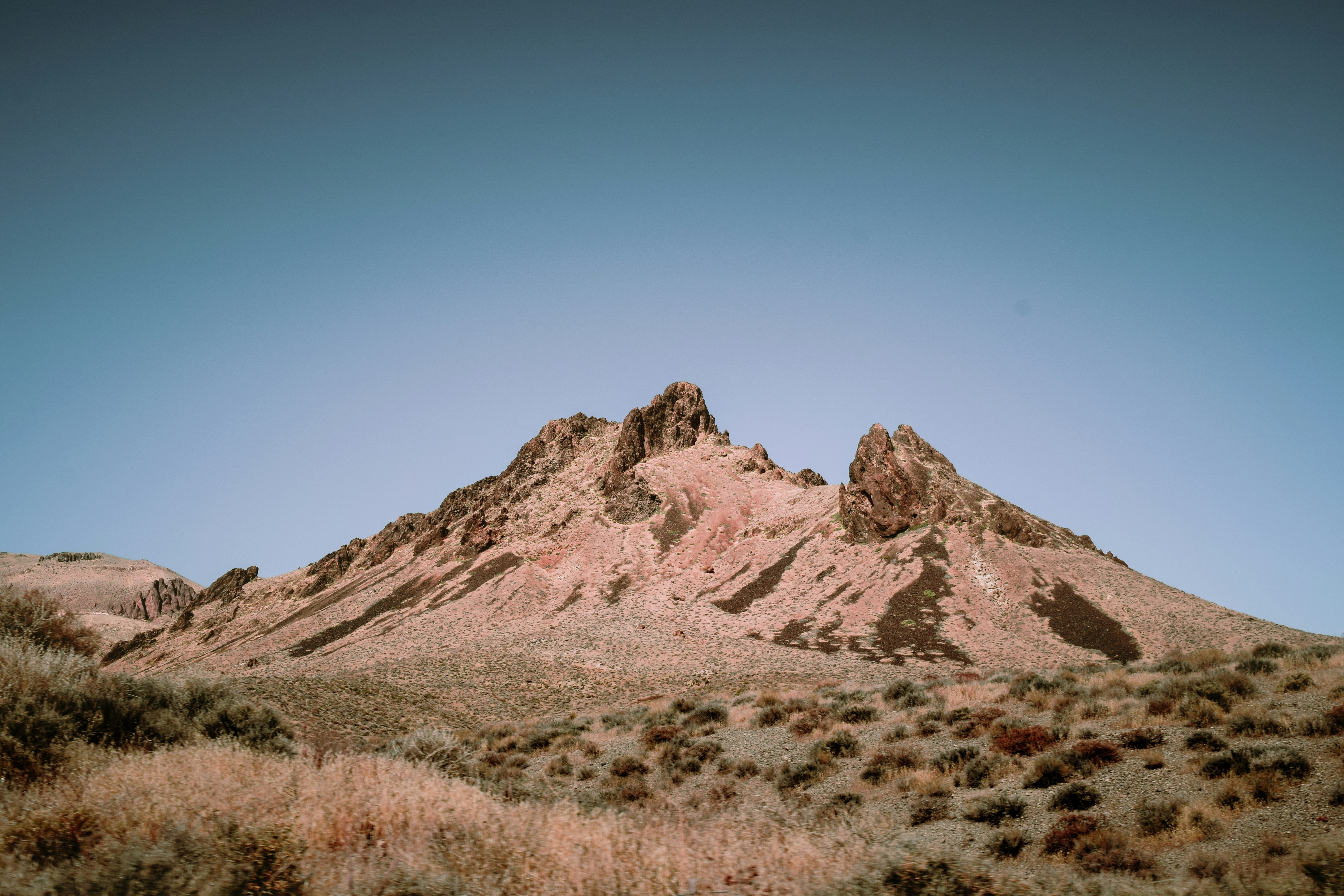 brown rocky mountain under blue sky during daytime, A beautiful mountain seen from one of the many off-road trails in Death Valley National Park.