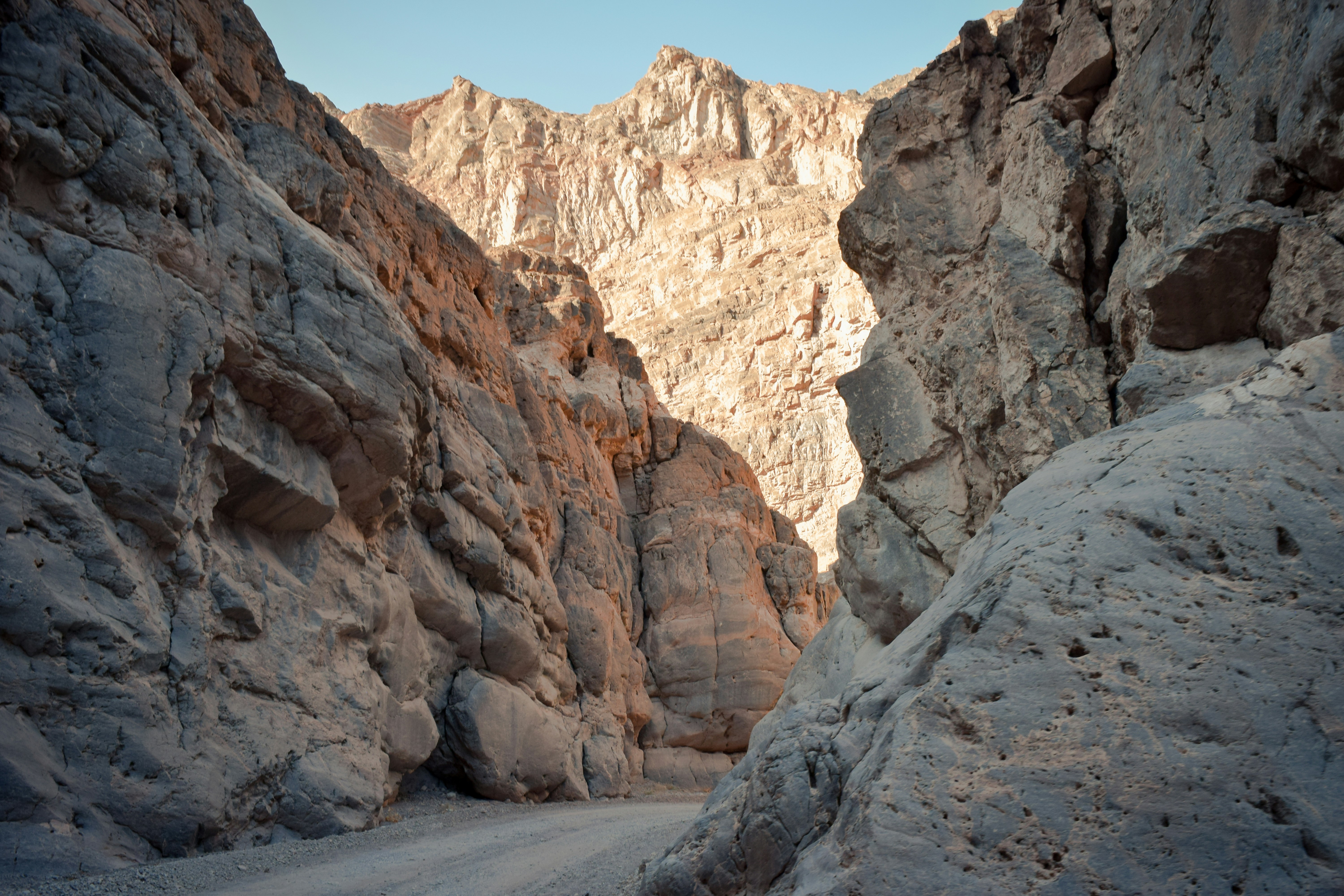 brown rocky mountain under blue sky during daytime, A beautiful canyon seen from one of the many off-road trails in Death Valley National Park.