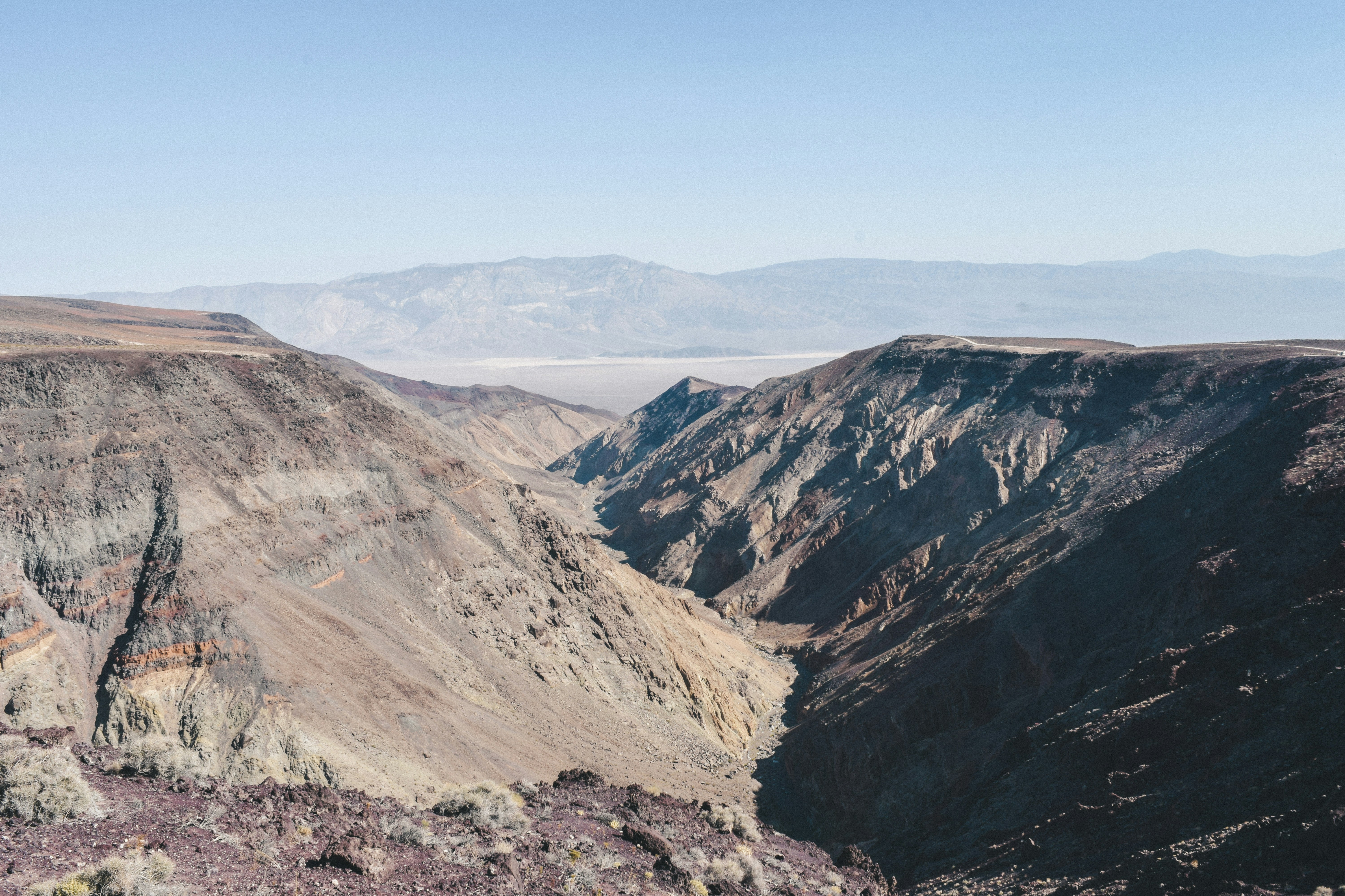 brown and gray mountains under blue sky during daytime, A beautiful lookout point from one of the many off-road trails in Death Valley National Park.