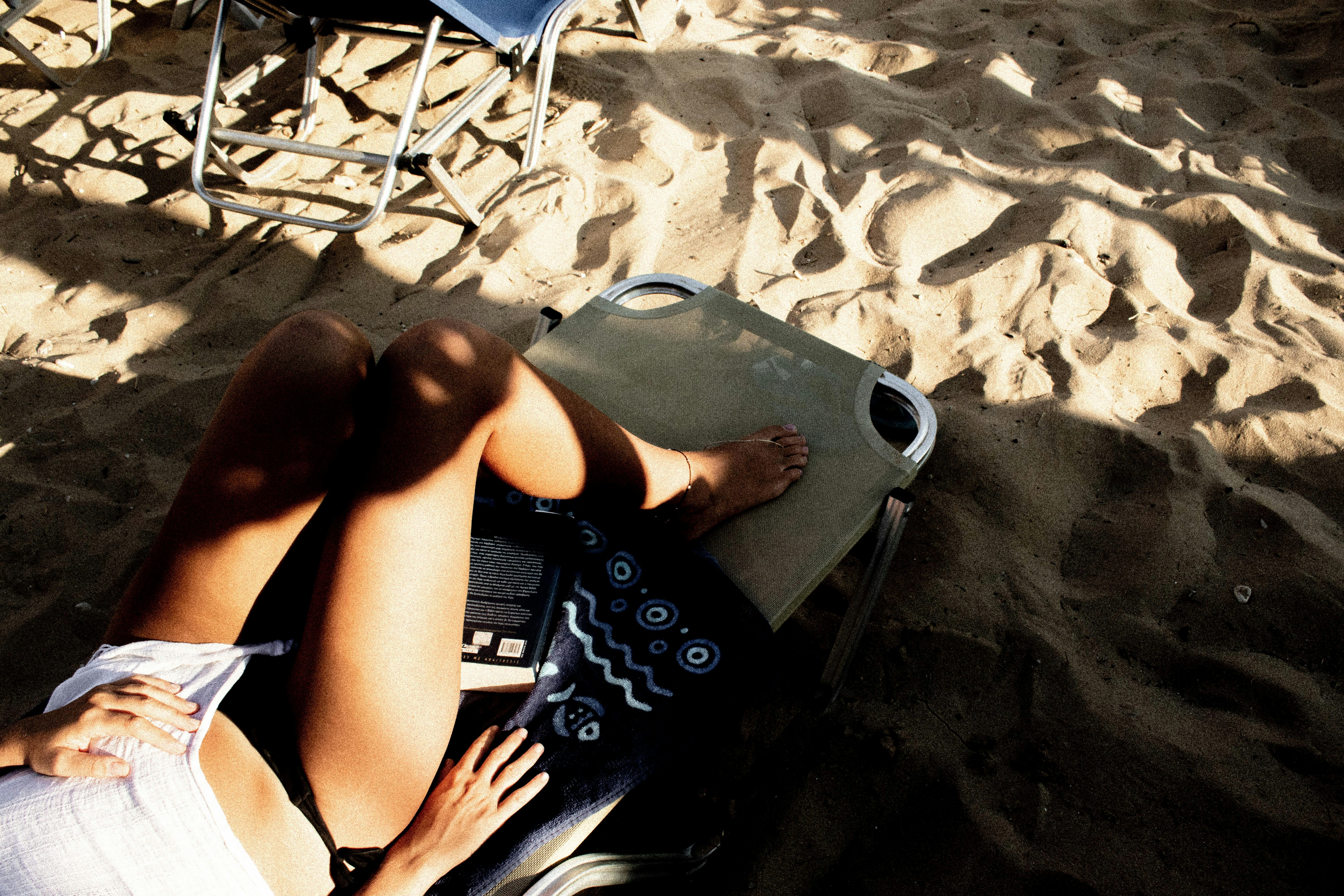 woman in black and white bikini lying on white beach lounge chair, Summer moments in Greece