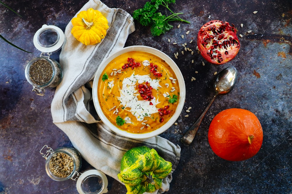 soup with sliced lemon on white ceramic bowl