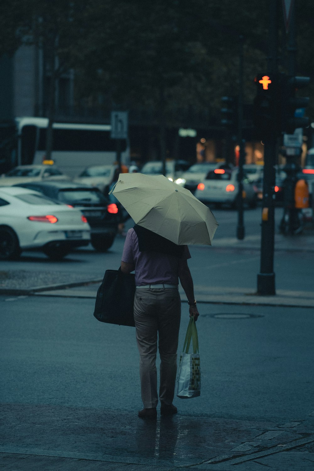 person in black jacket holding umbrella walking on street during daytime