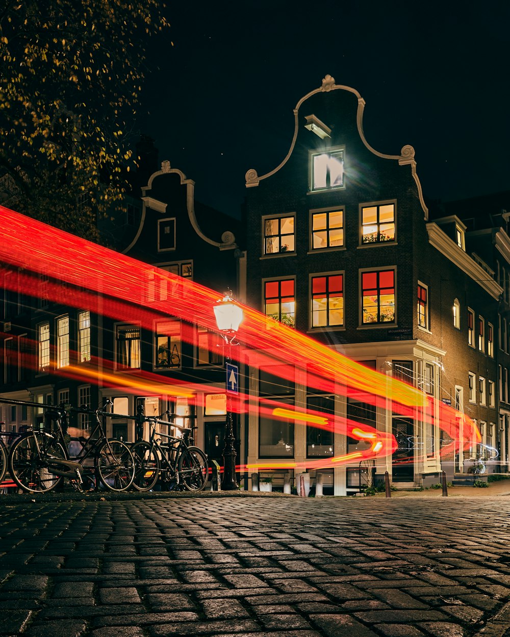 people walking on sidewalk near building during night time