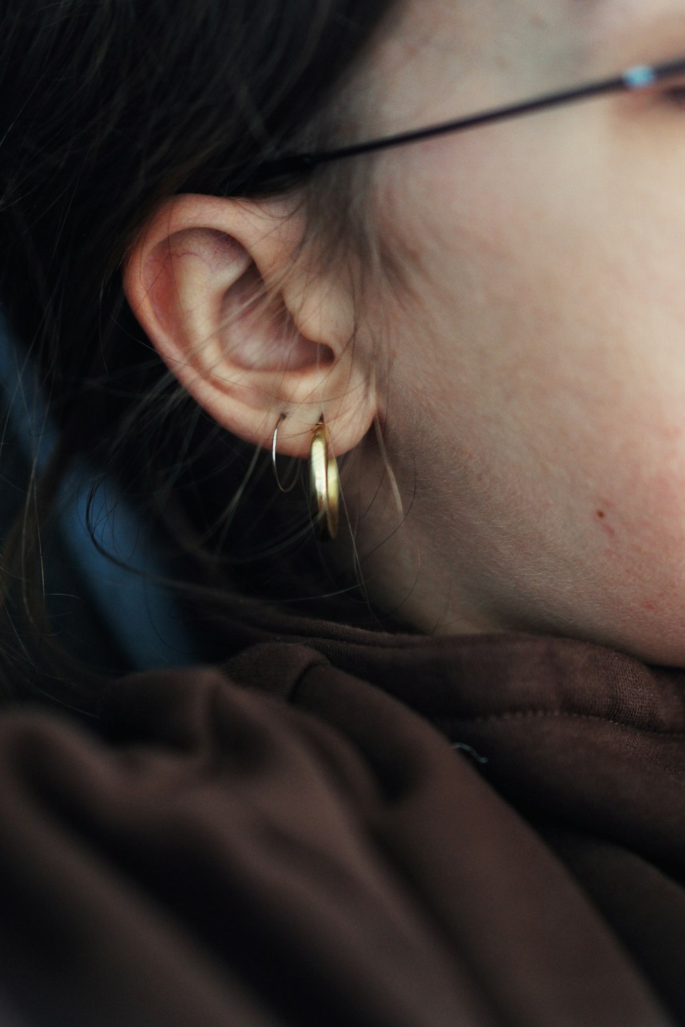 woman wearing gold hoop earring