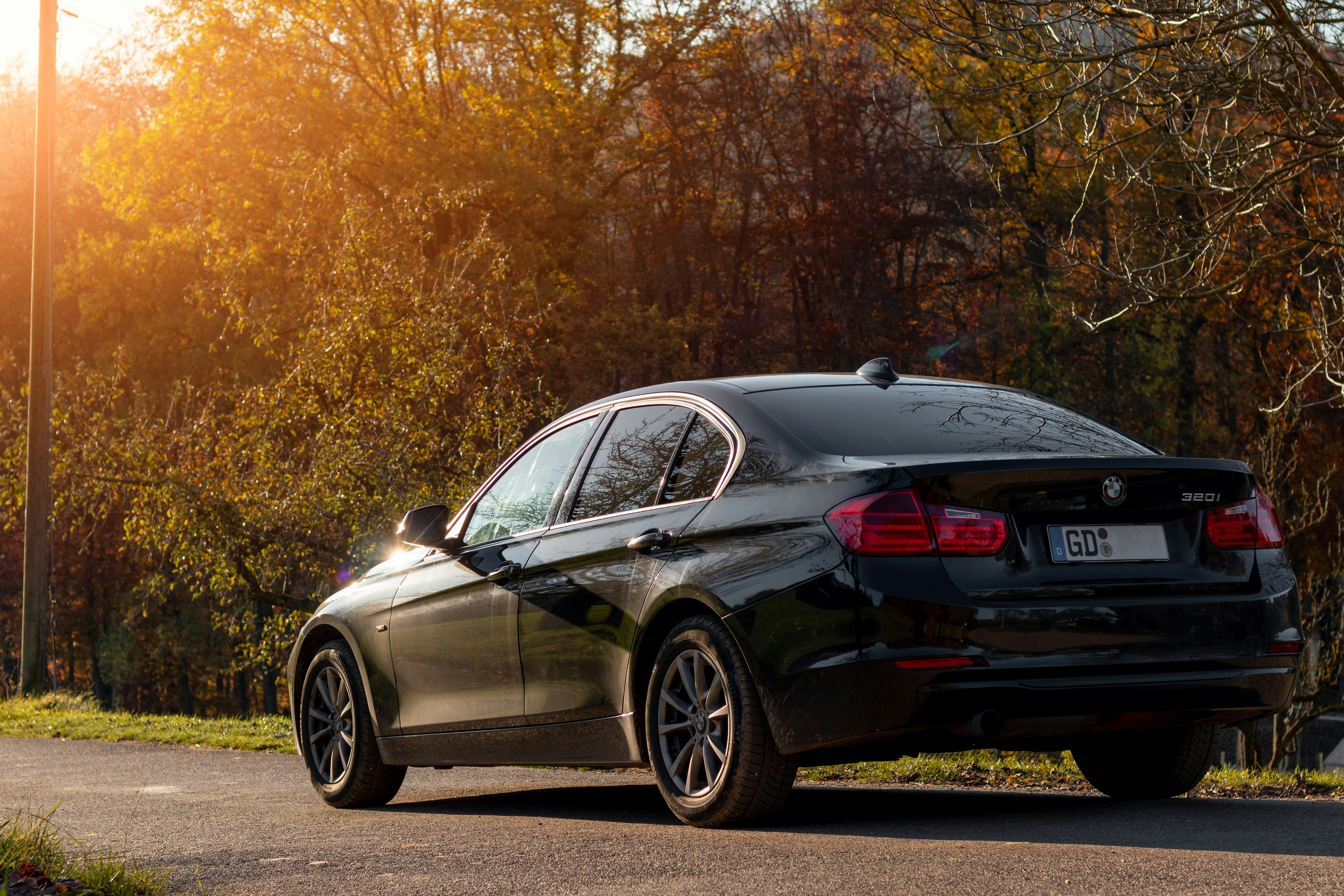 black mercedes benz coupe parked on gray asphalt road during daytime