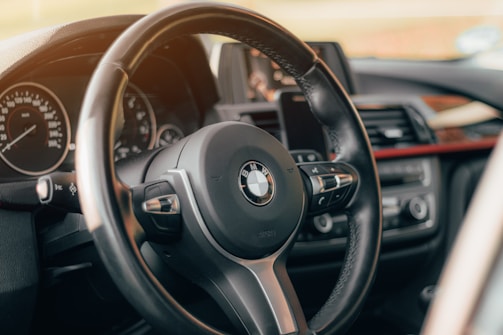 Close-up of a BMW dashboard displaying Apple CarPlay interface.